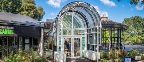 A museum with a glass structure and a gazebo.