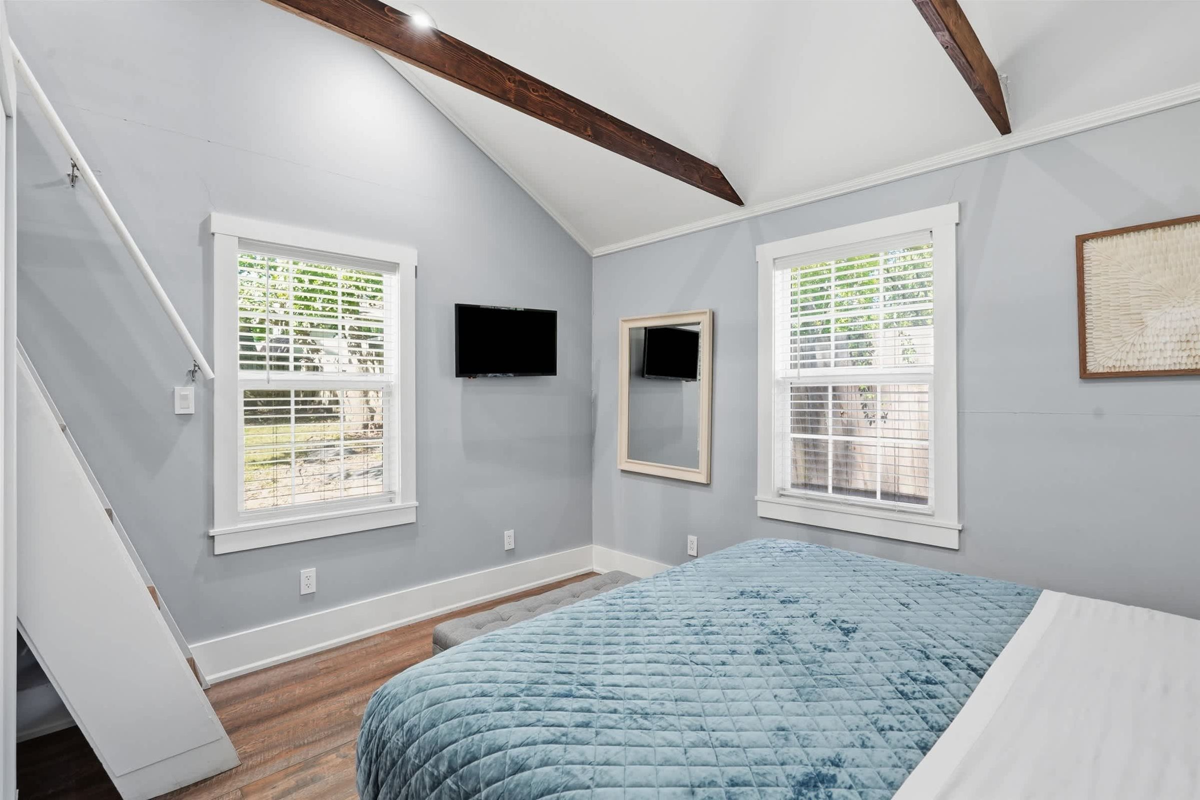 Primary sleeping area in Bedroom 1 featuring a comfortable king bed, soft neutral tones, and thoughtful lighting for a restful stay at Mission Outlook.