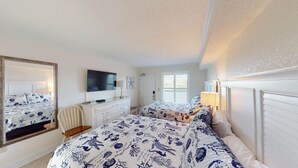 A bedroom with two beds, a TV, a dresser, and a mirror. - Seaside Bliss Oceanfront1 Bdrm Ste at Bridgewater (Pawleys Island)