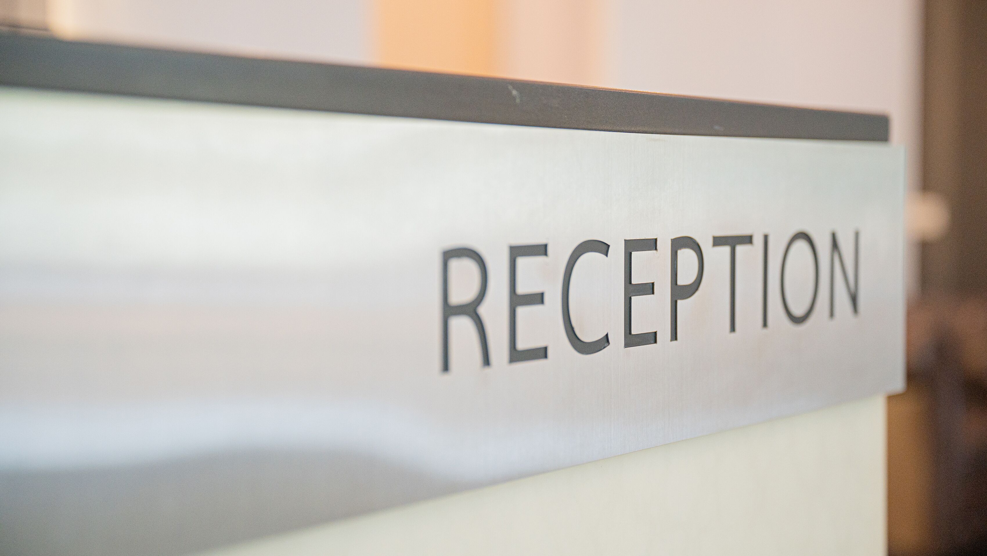 A reception sign with the word "RECEPTION" on it.