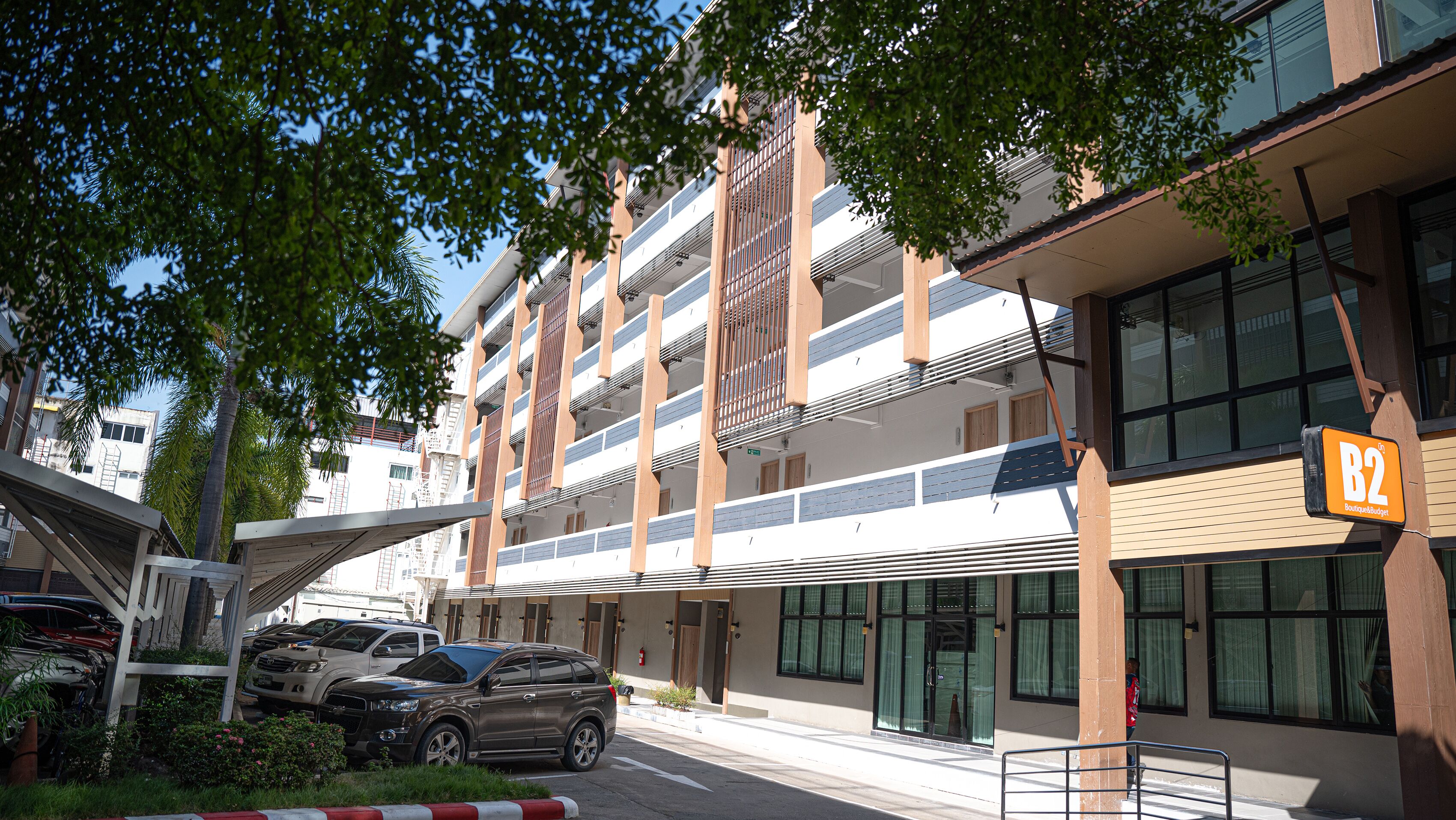A multi-story building with a modern design, featuring balconies and large windows.