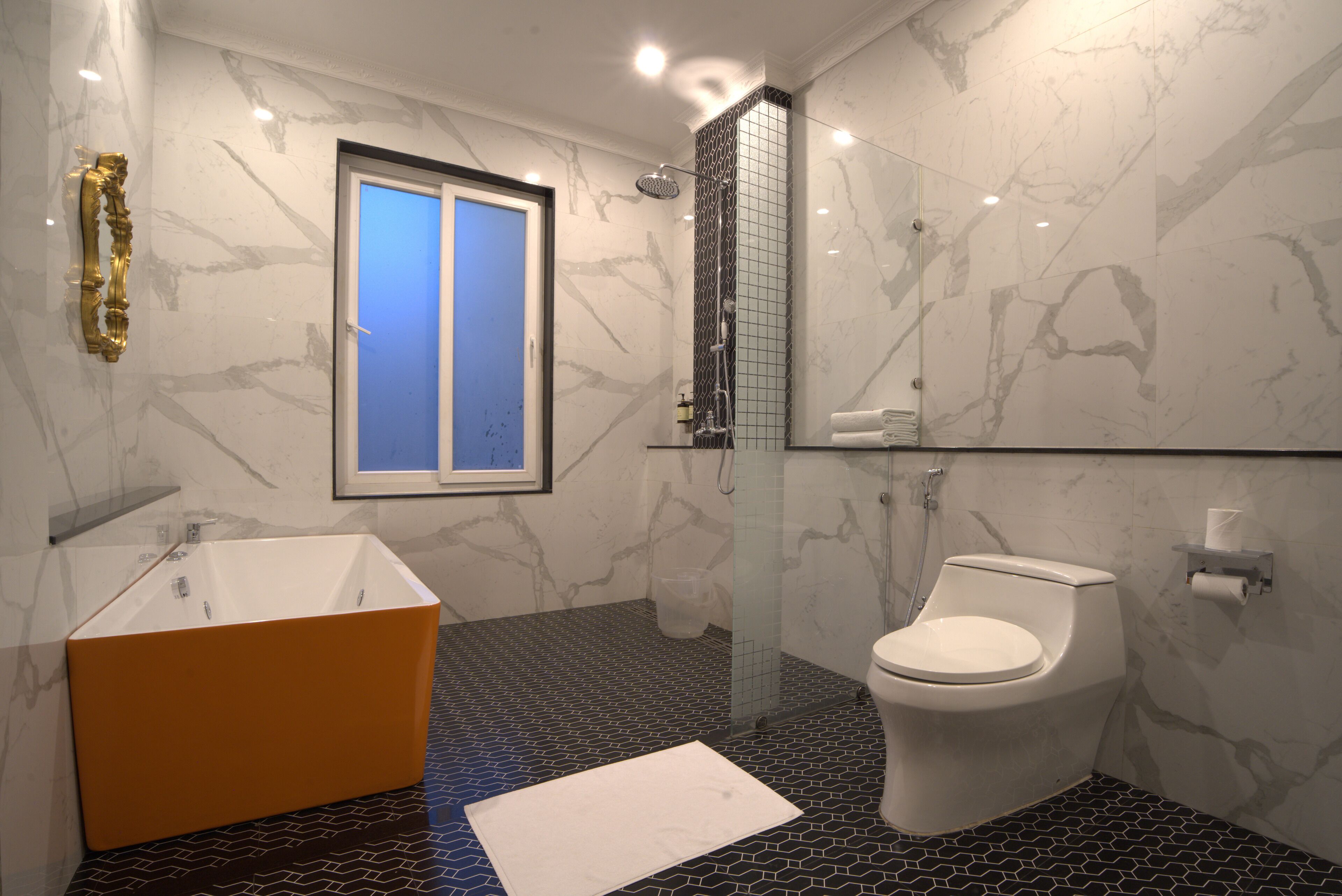 A bathroom with a bathtub, toilet, and a shower.
