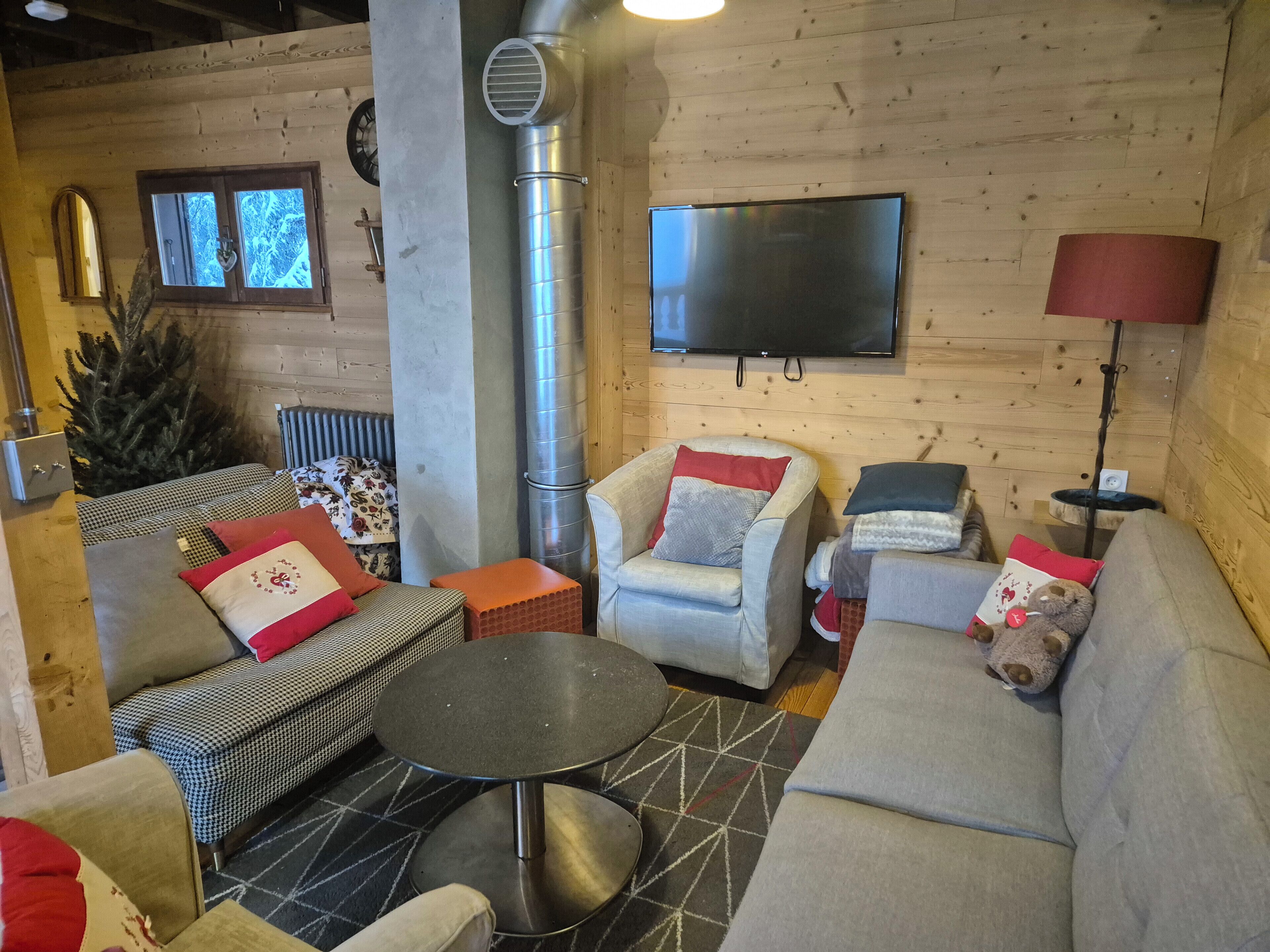 A cozy living room with a fireplace, a television, and comfortable seating.