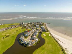 An aerial view of a coastal resort with a golf course, a river, and beachfront properties. - 332 Ocean Point (Fripp Island)
