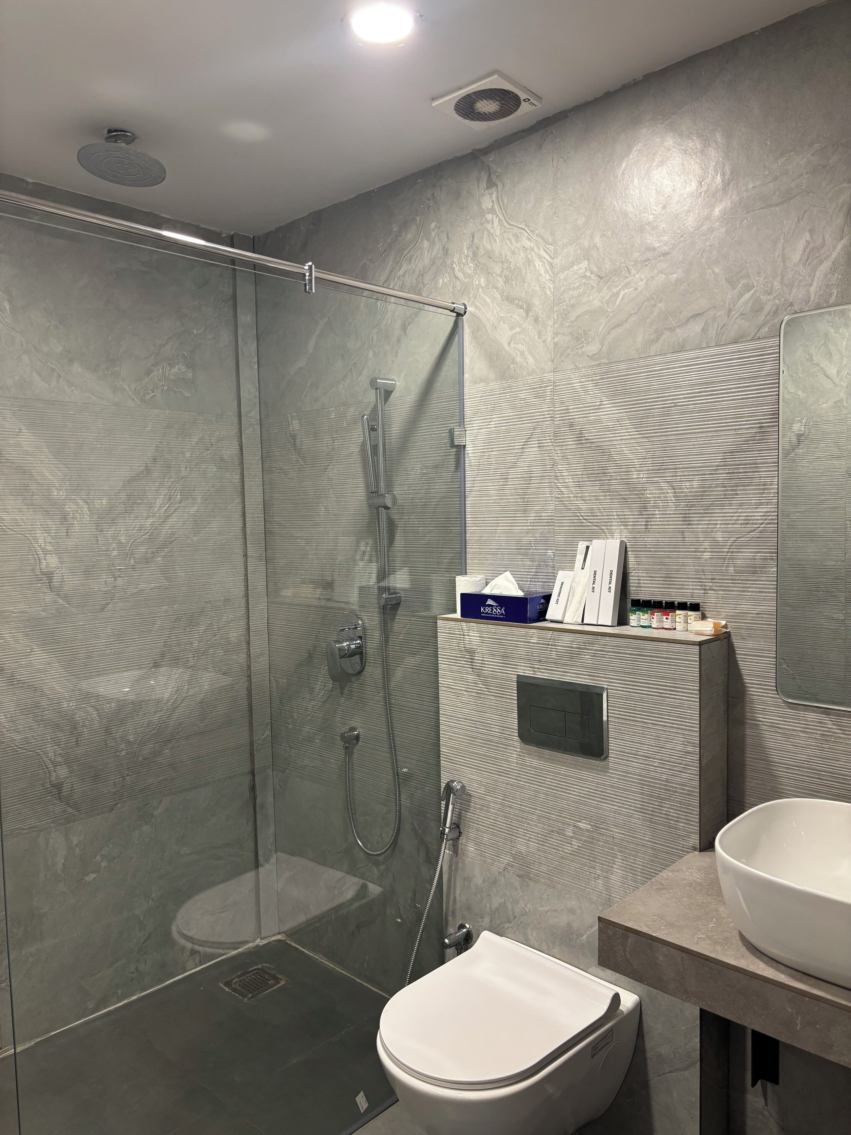 Een aparte badkuip en douche, een diep bad, een hydromassagedouche