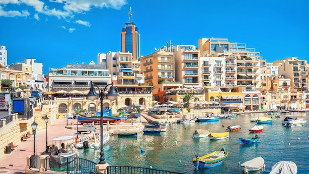 A coastal cityscape with a marina, buildings, and a prominent tower. - SwieqiStay room2 private bath - Paceville (Swieqi)