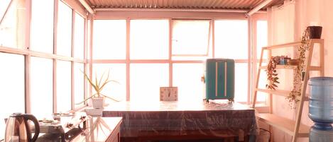 Una cocina con un banco de madera, un reloj y un dispensador de agua.