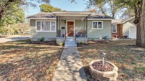 A single-story house with a front porch, a small front yard, and a pathway leading to the door. - Missouri Escape w/ Furnished Patio, Near Downtown! (Nevada)