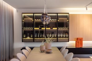 Enjoy meals with friends and family at this spacious dining area, featuring a long table and six comfortable chairs.