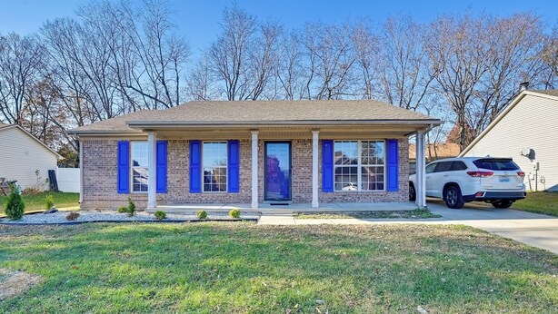 A single-story brick house with blue shutters, a front porch, and a driveway. - Georgetown Home ~ 6 Mi to Kentucky Horse Park! (Georgetown)