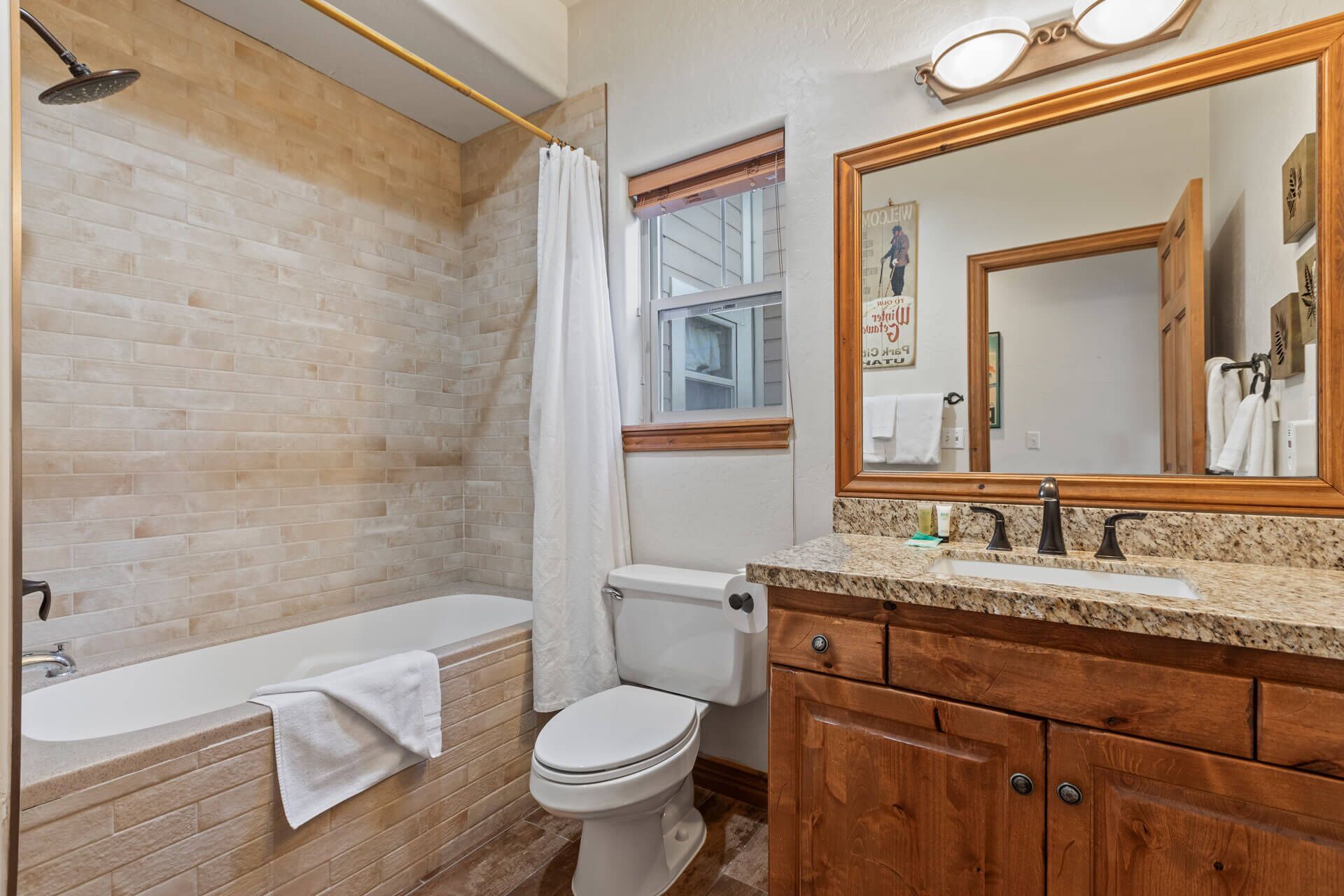 Unwind in your private bathroom with a soothing tub-shower combo, stylish tiling, and all the essentials to refresh after a day exploring the area.