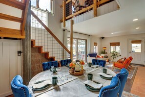 A spacious dining area with a high ceiling, a staircase, and a view of the outdoors. - Cortez Retreat w/ Hot Tub - 11 mi to Mesa Verde! (Cortez)