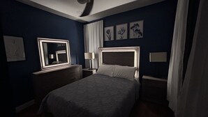 A bedroom with a bed, bedside tables, a mirror, and wall art. - The Blue backyard studio suite!!  Convenience and practicality in one place!! (Allentown)