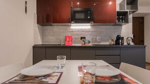 A modern kitchen with a microwave, coffee maker, and a red box on the counter. - Special 10 apartment by Wonderful Italy (Torino)