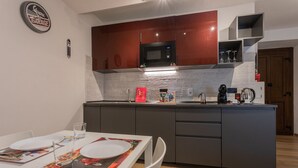 A modern kitchen with dark cabinets, a microwave, and a coffee maker. - Special 10 apartment by Wonderful Italy (Torino)