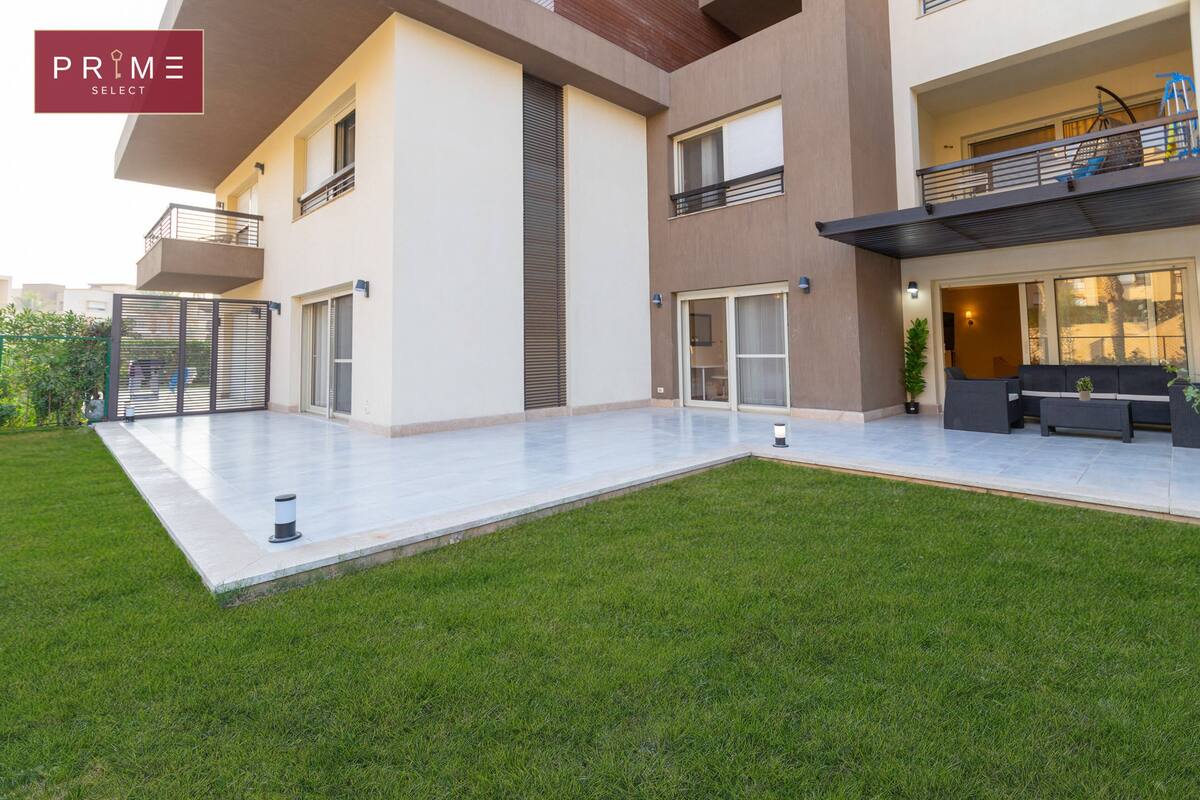 A modern apartment with a spacious balcony, a well-maintained lawn, and a clean, contemporary design.