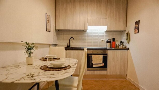 A compact kitchen with a marble countertop, a built-in oven, and a sink. - Pez's newly renovated house! (Roma)