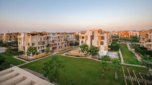 A residential complex with multiple apartment buildings, green lawns, and pathways.