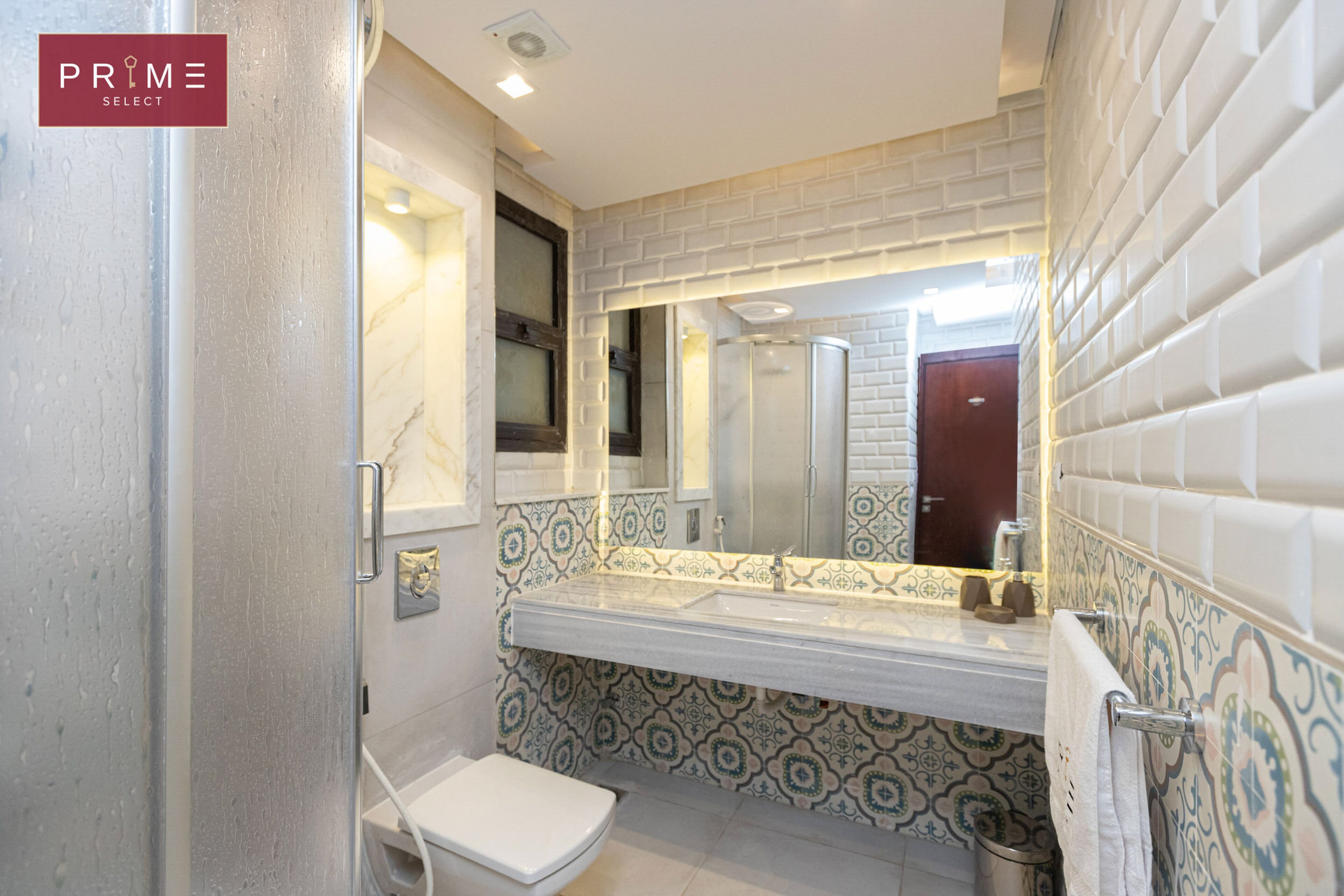 A bathroom with a white toilet, a sink, and a mirror.