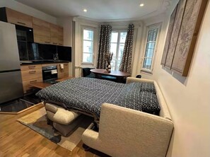Enjoy a compact room with a kitchenette, dining area, and cozy bed, offering city views.