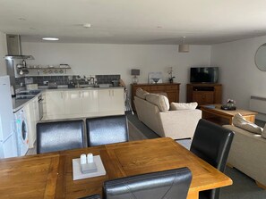 A compact living space with a kitchenette, dining area, and seating area.