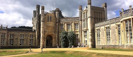 A historic building with a central tower, large windows, and a symmetrical facade.