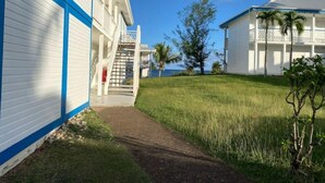 Un hôtel doté d’une passerelle couverte, d’un escalier et offrant une vue sur l’océan.