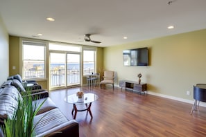 Relax in this stylish living room with a sofa set, flat-screen TV, and dining area.