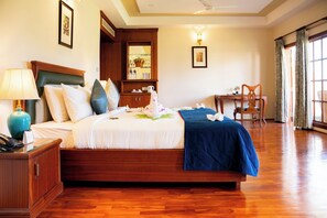 A hotel room with a wooden bed, a desk, and a chair.