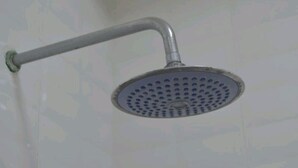 A showerhead with a curved arm and a circular head. - Birhanu Home stay (Lalibela)