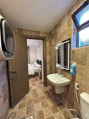 A hotel bathroom with a shower, sink, and mirror. - 3 Antica Jabalal-lwebdeh (Amman)