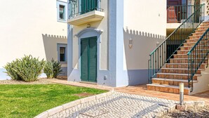 A two-story building with a balcony, a staircase, and a door. - 61B  Apartment in the Heart of Gramacho Gof Complexo (Estômbar)