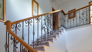 A multi-level staircase with ornate metal railings and wooden steps.