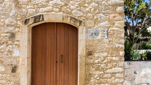 A stone building with a wooden door and a sign that reads "Villa ANI". - Ani Villa, authentic Cretan lifestyle (Rethymno)