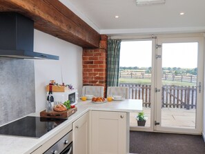 A kitchen with a microwave, toaster, and bread on the counter. - Hawthorn Cottage (Scarborough)