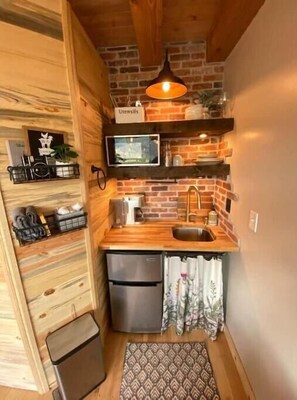 Fridge, microwave, coffee/tea maker, cookware/dishes/utensils