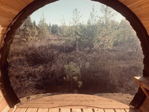A circular wooden structure with a view of a forested area. - The Forest Glamping Site! (Merville)