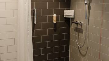 A bathroom with a shower, toilet, and sink.