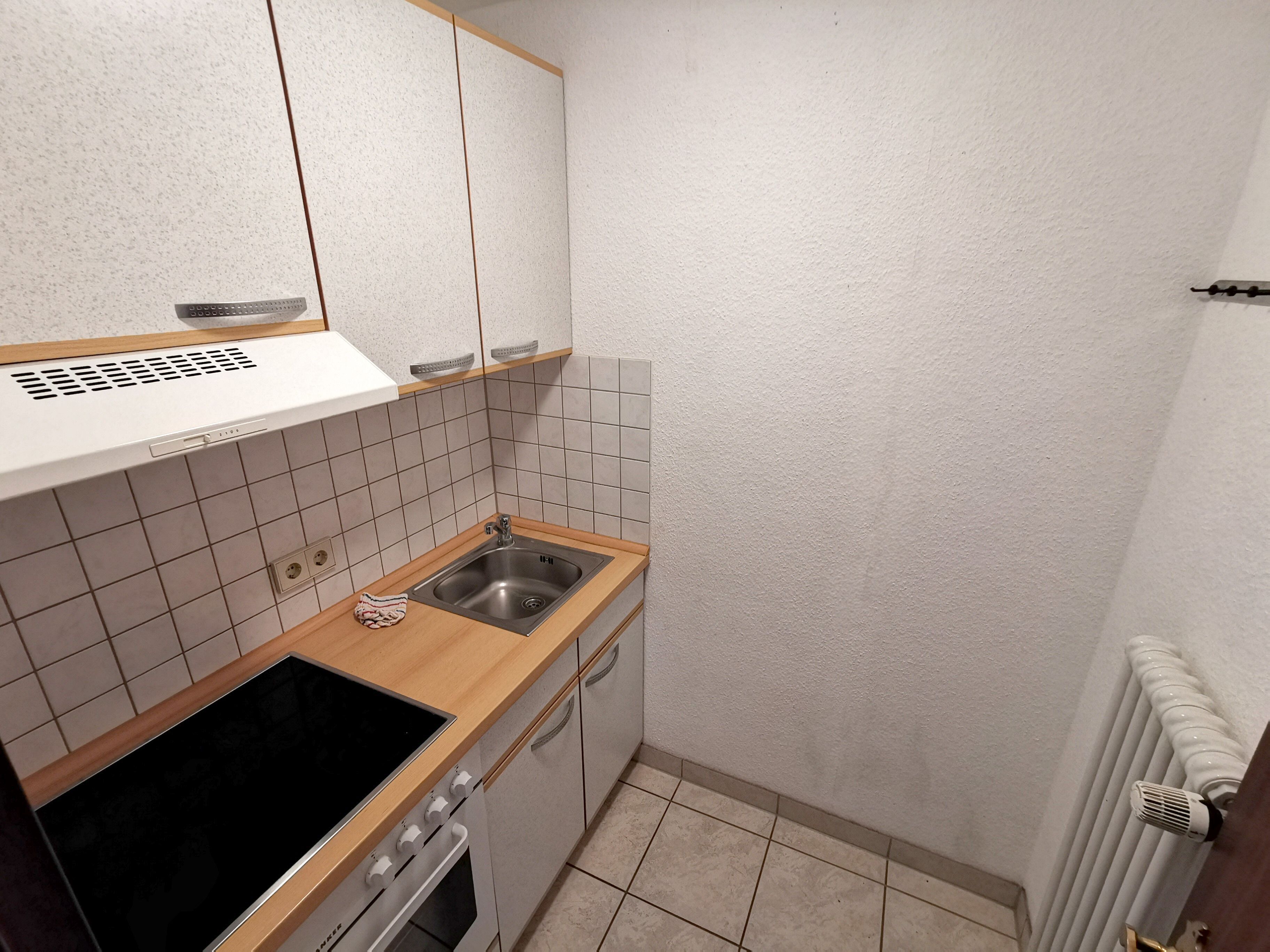 A compact kitchen with a stove, sink, and oven.