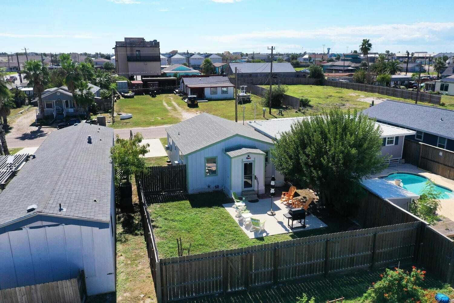 A residential area with a fenced backyard, a small shed, and a swimming pool.