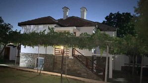 A two-story building with a stone wall and a staircase leading to the upper floor. - House Sleeps 6-garden-freeparking-bbq-patio-petsok (Karnobat)