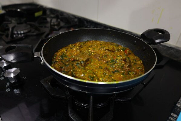 A pan of stew on a stove.