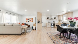 A modern apartment with a living room, dining area, and kitchen. - Beautifully Remodeled-Newly Furnished-Cozy, Colorful & Eclectic Home in N OKC!  (Oklahoma City)