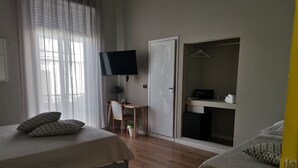 A hotel room with two beds, a desk, a TV, and a wardrobe. - Ace Rooms Vsg (Villa San Giovanni)