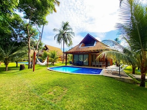 A resort with a swimming pool, a covered patio, and palm trees. - Lindos Bangalôs no Eco Resort  (Tamandaré)