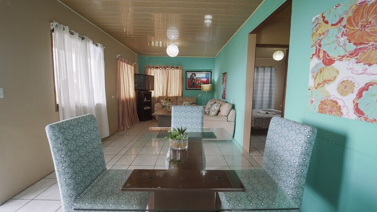 A living room with a sofa set, a coffee table, and a TV.