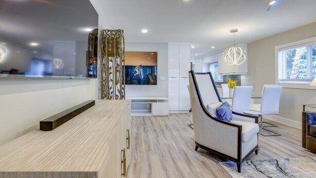A modern kitchen with a built-in oven, a dining area with white chairs, and a large window. - 2 Blocks to Riviera Beach: Upscale Condo w/ Patio (West Palm Beach)
