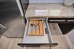Enjoy cooking in this well-equipped kitchen with a granite countertop and stainless steel appliances.
