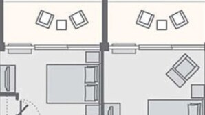 Distribución de una habitación de hotel con cama, escritorio, silla, armario y baño.