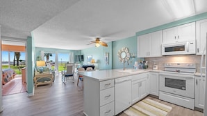 A modern kitchen with white cabinets, a built-in oven, and a microwave. - Gulf Shores Plantation-Palms 6109 (Gulf Shores)